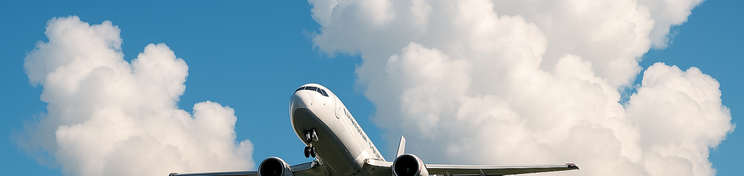 Air plane taking off with clouds